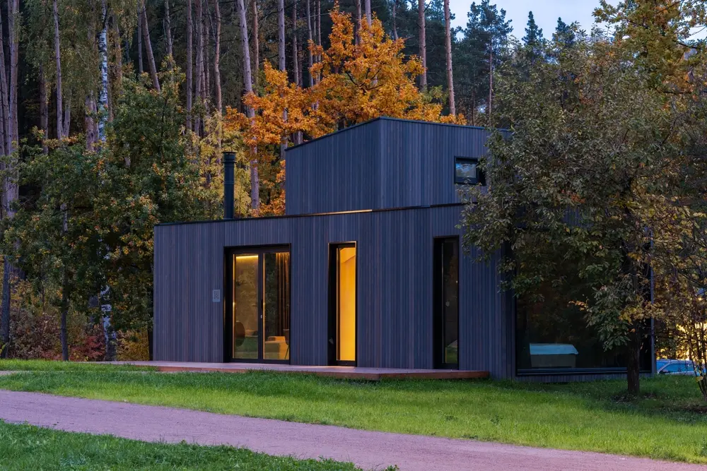 Image of a modern built house nested into nature.